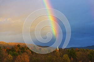 A rainbow over a New England church steeple