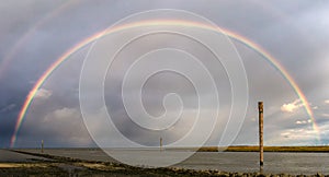 Rainbow over the North Sea island Wangerooge seen from Harlesiel.