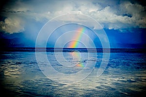 Rainbow over the ocean. rays rest, new zealand