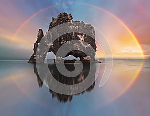 Rainbow over ocean rock, Iceland