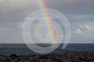 Rainbow Over Ocean and Rocky beach