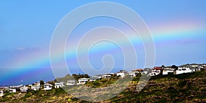 Rainbow over ocean view homes