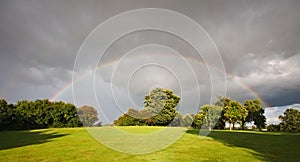 Rainbow over an orchard in summer