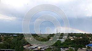 Rainbow over the park timelapse in rainy summer day