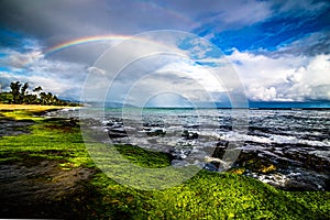 Rainbow over the popular surfing place Sunset Beach , Oahu, Hawaii