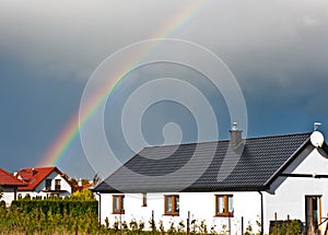 Rainbow over private house real estate optimistic future concept