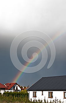 Rainbow over private house real estate optimistic future concept