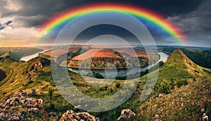 Rainbow over the river Dnister. Landscape with a rainbow in the sky