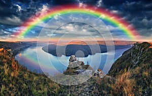 Rainbow over the river Dnister. Landscape with a rainbow in the sky