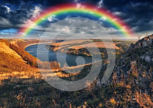 Rainbow over the river Dnister. Landscape with a rainbow in the sky