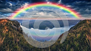 Rainbow over the river Dnister. Landscape with a rainbow in the sky