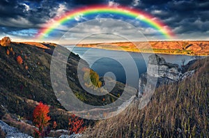 Rainbow over the river Dnister. Landscape with a rainbow in the sky