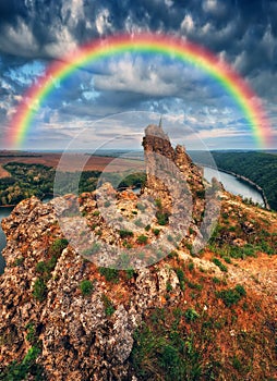 Rainbow over the river Dnister. Landscape with a rainbow in the sky