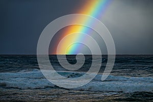 Rainbow over the rough Pacific Ocean