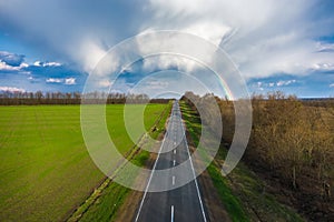 Rainbow over rural highway road spring landscape aerial view