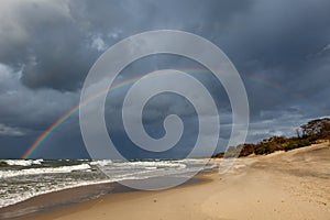 Rainbow over the sea and the beach.