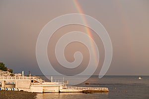 Rainbow over the sea and beach after the rain