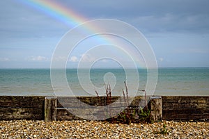 rainbow over the sea behind a pebble beach in dover