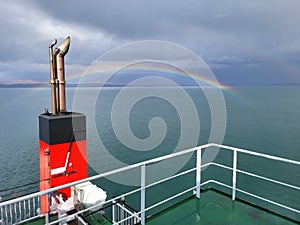 Rainbow over sea captured during ferry journey to Isle of Mull