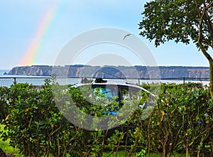 Rainbow over sea coast.