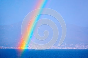 Rainbow over the sea and coastal city