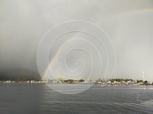 rainbow over the sea that separates the black and white sky