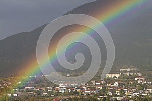 Rainbow over a small town in the mountains
