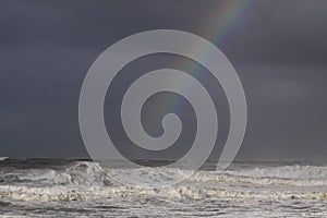 Rainbow over a stormy sea