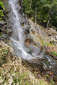 A rainbow over the stream of a waterfall