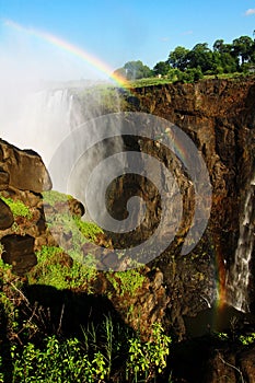 A rainbow over Victoria falls in Zimbabwe, Africa