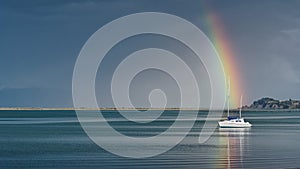 Rainbow over a yacht, Motueka seafront, Motueka, Tasman region, south island, Aotearoa / New Zealand