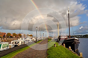 Rainbow over Zoutkamp haven with boats