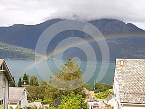 Rainbow panorama lanscape on the beach lake with mountain background with clouds on top