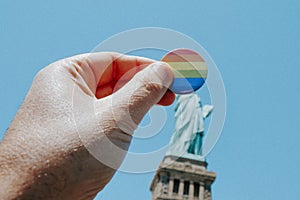 rainbow-patterned badge and the Statue of Liberty