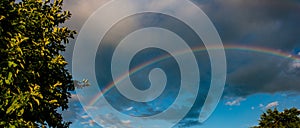 Rainbow in the rain and sunset in the countryside.