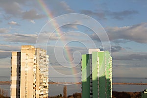 Rainbow after rain, two of the highest city buildings, beautiful sky, Black sea in the background