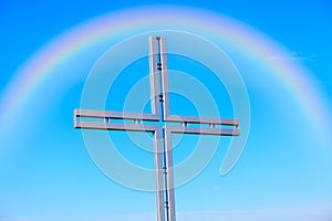 Rainbow and religious cross