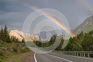 Rainbow road mountains clouds forest