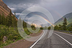 Rainbow road mountains clouds forest