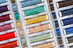 Rainbow sewing threads arrangement in a plastic container