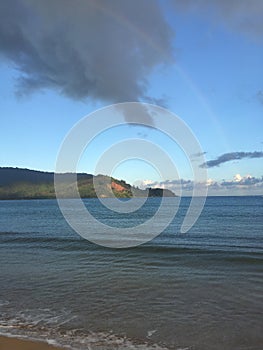 Rainbow in Sky after Rain during Sunrise in Hanalei Bay on Kauai Island, Hawaii.