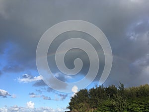 Rainbow in Sky Seen from Lumahai Beach on Kauai Island, Hawaii.