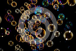 Rainbow soap bubbles on black background