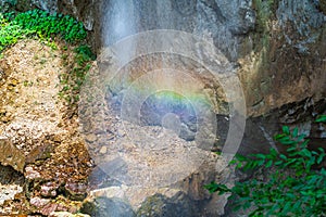 Rainbow spray in a waterfall