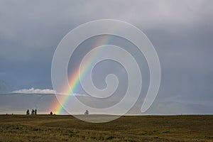 Rainbow steppe mountains fog clouds summer