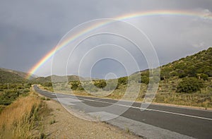 A rainbow stretching over the highway