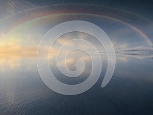 Rainbow sunbeam  on blue sky sunset on sea water reflection  nature landscape background  summer template