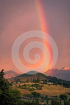 A rainbow in a sunset sky over a hill in Clarens, South Africa