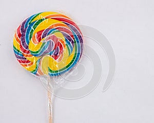 Rainbow swirl sucker, cellophane covered lollipop