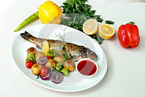 Rainbow trout with grilled vegetables and citrus sauce